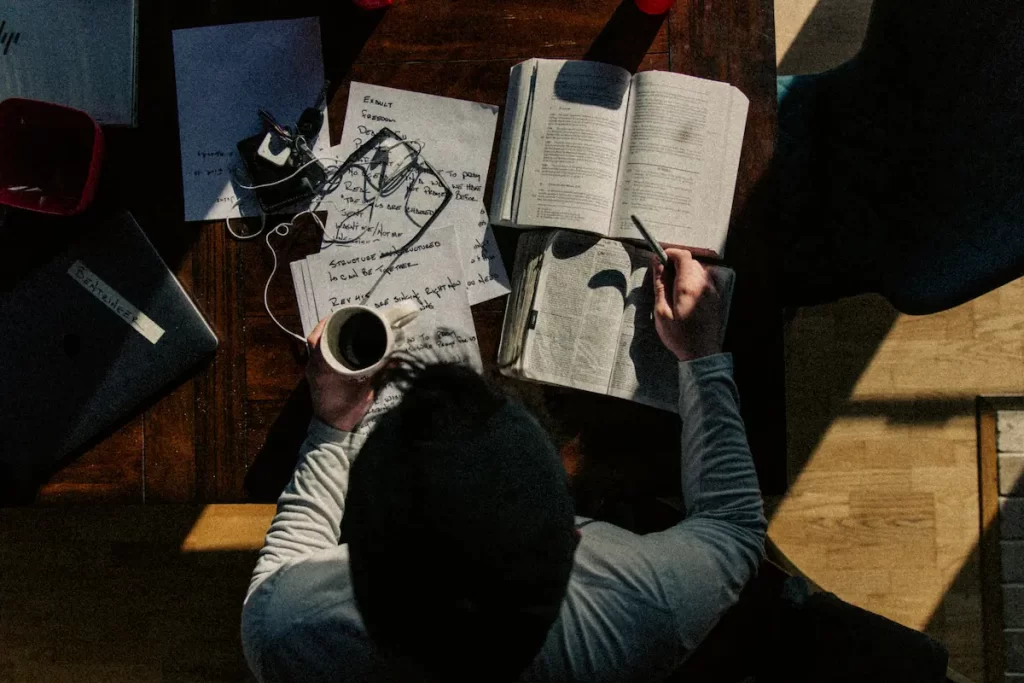 本やノートをひろげて勉強している人の写真。
